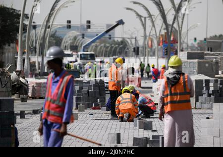 Doha, Qatar. 20th mars 2022. Les travailleurs de la construction renouvellent leurs chemins dans le centre-ville de Doha. De nombreuses rues sont actuellement en cours de refonte à l'approche de la coupe du monde. Le Qatar est à maintes reprises critiqué pour son traitement des travailleurs étrangers. Le ministre allemand de l'économie et de la protection du climat, Habeck, effectue une visite de trois jours dans le golfe Persique. Credit: Bernd von Jutrczenka/dpa/Alamy Live News Banque D'Images