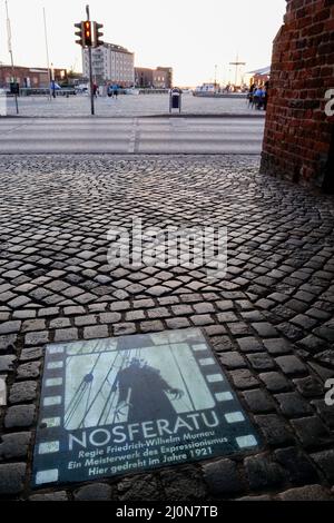 ALLEMAGNE, Wismar à la mer Baltique, plaque commémorative du film classique allemand Nosferatu de Friedrich-Wilhelm Murnau à l'ancien wassertor hanséatique au port, quelques parties du film silencieux où tourné dans la vieille ville historique en 1921, Le sujet du film est une histoire de Vampire inspirée par le livre Dracula de Bram Stoker / DEUTSCHLAND, Wismar, die historische Altstadt ist UNESCO Welterbe, Wassertor am Spiegelberg am Hafen, Infotafel zum deutschen film Nosferatu, Wilhelm wurden 1921 Teile des Stumfilm Klamker von HAFNASSICHT-Friedrich MURREDATU Banque D'Images