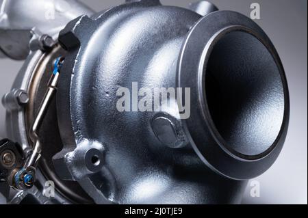 Auto pièces nouvelle turbine mécanique en métal sur fond gris. Gros plan. Compresseur d'échappement turbo mécanique Banque D'Images