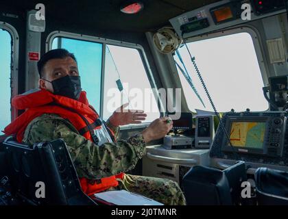 220126-N-YL048-1034 MANAMA, BAHREÏN. (Janv 26, 2022) Cmdr. Ernesto Rivera, officier exécutif de la Naval support Activity (NSA) Bahreïn, explique les règles de la route aux membres de l'équipage lors d'une inspection bihebdomadaire de l'unité de patrouille portuaire (HPU). L'UHP fournit une protection constante contre le terrorisme afin d'assurer la sécurité des navires entrants et sortants dans le cadre des opérations de sécurité maritime. La NSA Bahreïn permet aux forces américaines et alliées de faire avancer les opérations et de réagir en soutien à la mission de la Marine Region Europe, Afrique, Central de fournir des services à la flotte, warfighte Banque D'Images