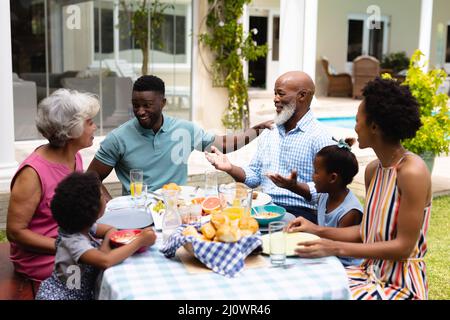 Une famille afro-américaine heureuse de trois générations prenant un brunch à l'arrière-cour Banque D'Images