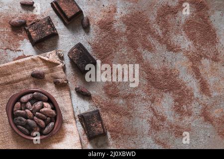 Poudre de cacao dispersée avec morceaux de chocolat cacao bol de fèves Banque D'Images