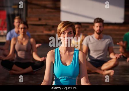 Le yoga vous permet de mieux vous faire. Un groupe de personnes faisant du yoga ensemble. Banque D'Images