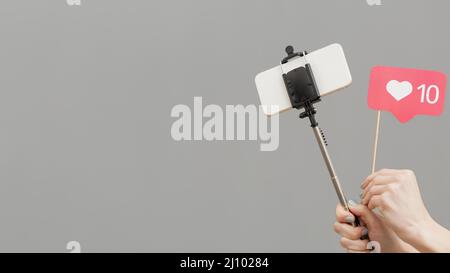 Gros plan blogger tenant selfie Stick avec téléphone mobile Banque D'Images