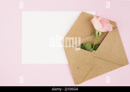 Enveloppe blanche vierge marron avec fond rose rose Banque D'Images