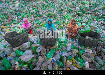 Les travailleurs trient les bouteilles en plastique usagées dans une usine de recyclage située à Noakhali, au Bangladesh. Ces bouteilles sont principalement collectées par des motards et des enfants de la rue, qui seront plus tard vendus aux usines locales. Les usines de tous les jours comme celles recyclent des milliers de bouteilles pour fabriquer différents types de produits en plastique. Avec le plastique qui ne se défait jamais, le recyclage du plastique au Bangladesh est une grande industrie de nos jours. Bangladesh. Banque D'Images