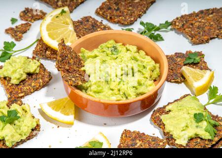 Guacamole maison avec frites sans gluten. Guacamole, hors-d'œuvre de légumes, pâte d'avocat. Régime de céto sain à base de plantes. Banque D'Images