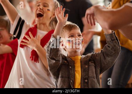 De jeunes fans allemands de football célèbrent la victoire de leur équipe au stade. Banque D'Images