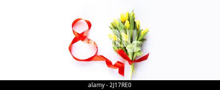Bannière horizontale avec numéro huit rouge et tulipes jaunes sur blanc avec espace de copie. Arrière-plan pour la journée des femmes, 8 mars. Style de pose à plat, vue de dessus Banque D'Images