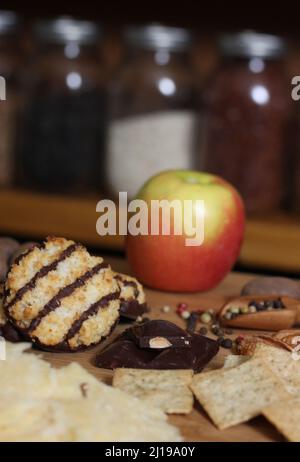 Fromage irlandais avec chocolat belge et macarons à la noix de coco italienne dans une cuisine rustique Banque D'Images