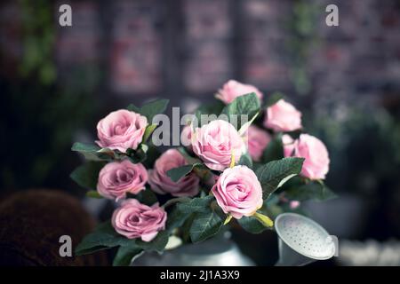 Seau avec fleurs et décoration de pâques en studio, roses roses Banque D'Images