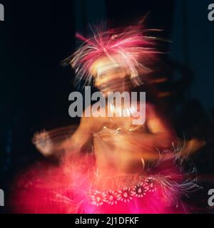 Danseuse polynésienne dansant la hula (hura) dans les îles Cook te Mire Ura, compétition nationale danseuse de l'année, Rarotonga. Mouvement flou. Banque D'Images