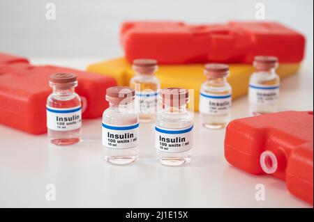 Ampoules d'insuline avec des sachets froids sur fond blanc : refroidissement et stockage corrects de l'insuline. Banque D'Images