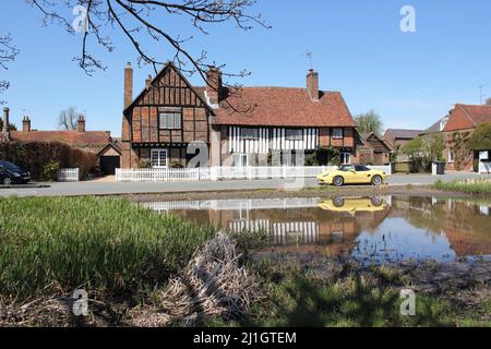 Pond & The Old Manor House avec voiture de sport jaune garée, Aldbury Village à Spring, Hertfordshire, Angleterre, Royaume-Uni Banque D'Images