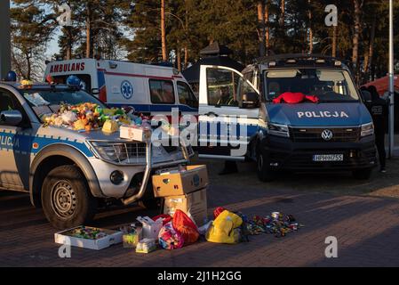 Hrebenne, Pologne. 18th mars 2022. Deux voitures de police avec un grand nombre de jouets donnés sur le dessus vu devant un centre temporaire de réfugiés. Principal point d'accès à la Pologne, la gare principale de Przemy?l près de la frontière de Medyka reçoit un grand nombre de réfugiés qui viennent en bus vers Varsovie et Cracovie en train. Chaque jour, des bénévoles fournissent de l'aide et de la nourriture. (Credit image: © Natalia Campos/SOPA Images via ZUMA Press Wire) Banque D'Images