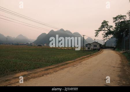 Cinematic scenery of fogs covering the karst mountains in rural Bac Son in Vietnam Stock Photo