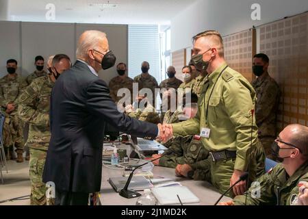 Le président américain Joseph R. Biden Jr. Salue les soldats polonais lors d'une visite à Jasionka, en Pologne, le 25 mars 2022. Le Président Biden a rendu visite à des membres de la Division aéroportée de 82nd et à des alliés polonais qui travaillent actuellement ensemble à l'appui de l'Alliance de l'OTAN le long de son flanc est. (É.-U. Photo du corps marin par Sgt. Claudia Nix) Banque D'Images