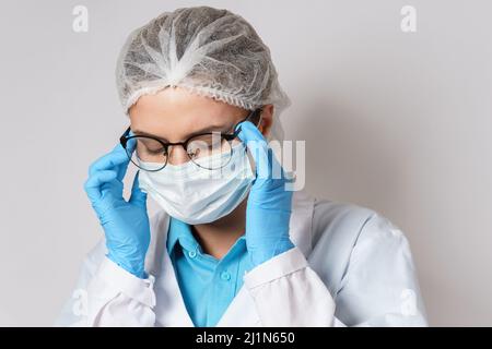 Fatigue - jeune femme médecin avec un mal de tête Banque D'Images