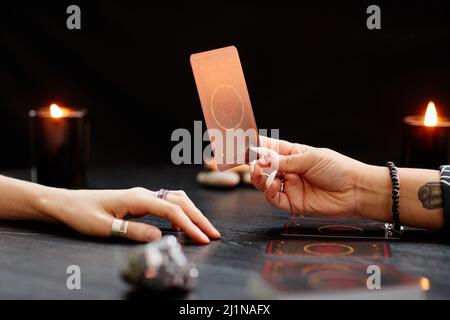 Une femme qui présente des cartes de tarot pour une jeune femme qui visite un lieu de séjour spirituel, un espace de copie Banque D'Images