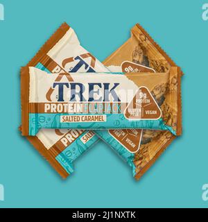 SWINDON, Royaume-Uni - 27 MARS 2022: TREK Protein Flapjack barres salées de caramel, végétalien et sans gluten sur un fond bleuâtre léger Banque D'Images