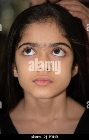 Jeune fille indienne d'âge scolaire posant, regardant la caméra. Banque D'Images