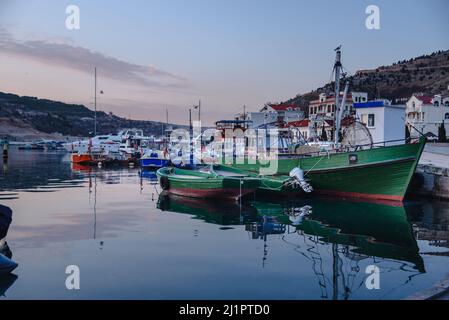 Vue sur les bateaux dans la baie de Balaklava près de la jetée au printemps au coucher du soleil. Crimée Banque D'Images