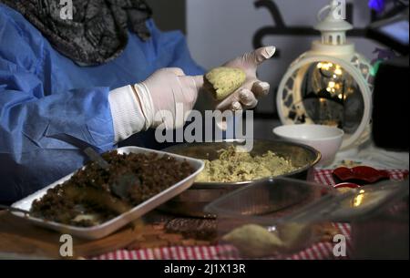 Gaza. 28th mars 2022. Un palestinien prépare de la nourriture qui sera vendue pendant le mois Saint islamique du Ramadan dans un magasin de nourriture dans la ville de Khan Younis, dans la bande de Gaza, le 28 mars 2022. Crédit: Emad Drimly/Xinhua/Alamy Live News Banque D'Images