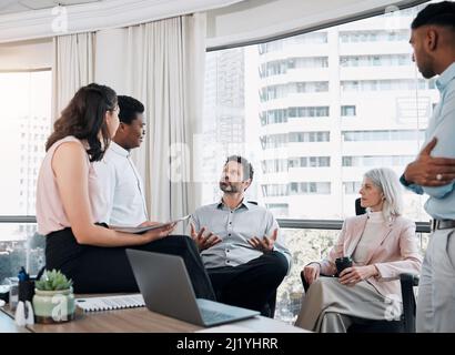 Apprendre des meilleurs. Photo d'un groupe diversifié d'hommes d'affaires ayant une discussion au bureau. Banque D'Images