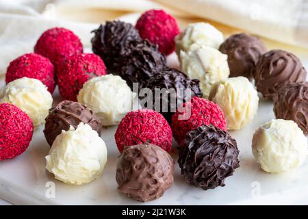 Assortiment de chocolats aux truffes sur fond blanc. Pralines au chocolat maison. Gros plan Banque D'Images