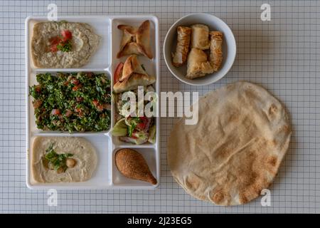 Vue de dessus d'une assiette de spécialités libanaises, un pain pita et un bol de pâtisseries Banque D'Images