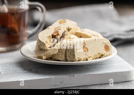 Halva de tahini sucré aux amandes. Dessert turc sur une assiette. Banque D'Images