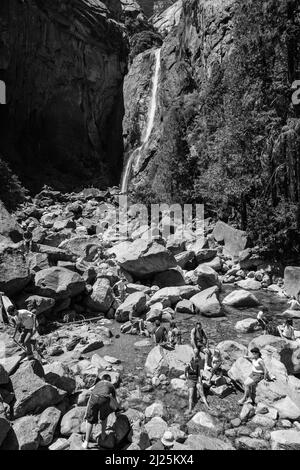 Yosemite Park, États-Unis - 22 juillet 2008 : les touristes rafraîchissent leurs jambes dans le lac de la chute d'eau inférieure de Yosemite, États-Unis. En 1890, le Congrès américain Banque D'Images