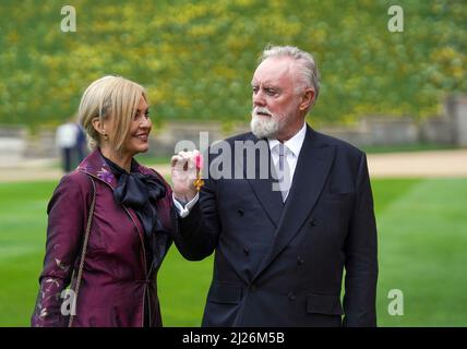 Le batteur de la reine Roger Taylor avec sa femme Sarina, après avoir été fait OBE par le prince de Galles lors d'une cérémonie d'investiture au château de Windsor. Date de la photo: Mercredi 30 mars 2022. Banque D'Images