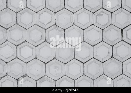 Mur avec nid d'abeille en béton. Carreaux hexagonaux gris en béton, carreaux en nid d'abeille texture arrière-plan Banque D'Images