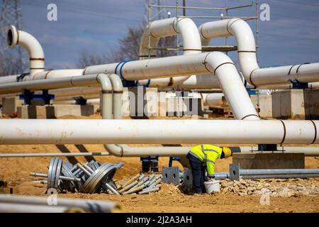 Le travailleur travaille sur un site de construction d'un pipeline de transport de gaz naturel interconnecté. Réseau hautement intégré qui déplace le gaz naturel. Connecteur Banque D'Images