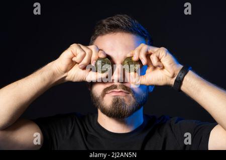 Amoureux de Bitcoin avec la pièce d'or par les yeux. Symbole numérique d'une nouvelle monnaie virtuelle. Cryptocurrency. Banque D'Images