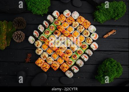 Au-dessus de la vue de divers sushis et des petits pains placés sur un plateau en pierre. Fête de la cuisine japonaise. Vue de dessus, plan d'appartement Banque D'Images