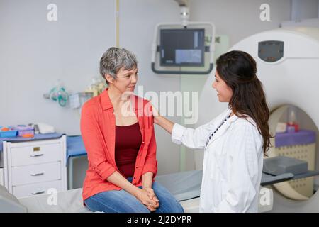 Nous avons vos résultats d'analyse. Prise de vue d'une femme mûre étant réconfortée par un médecin avant et IRM. Banque D'Images
