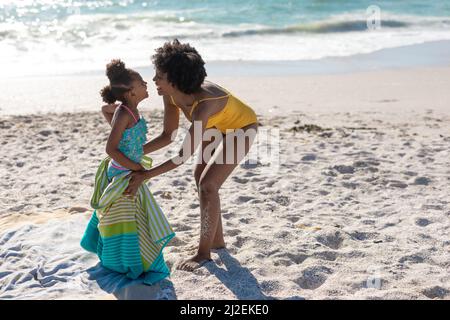 Pleine longueur de bonne mère et fille afro-américaine appréciant la journée ensoleillée à la plage Banque D'Images