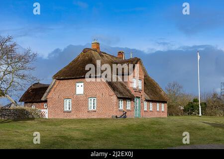 List, Allemagne - 17 février 2021: Maison frisonne en brique rouge typique avec toit de chaume sur l'île de Sylt dans le village de List, Allemagne. Banque D'Images