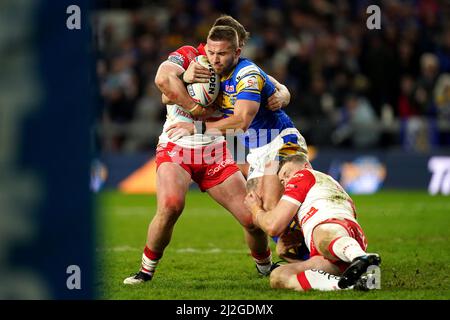 Le Jack Walker de Leeds Rhinos (au centre) est abordé par Joe Batchelor de St Helens (à gauche) et Morgan Knowles lors du match de la Super League de Betfred au stade Headingley, à Leeds. Date de la photo: Vendredi 1 avril 2022. Banque D'Images