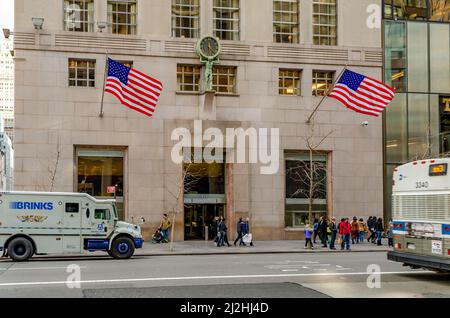 Entrée du Tiffany & Co Store Building avec des personnes qui marchent devant Fifth Avenue, American Flags pendant le bâtiment, bus et camions passant par Banque D'Images