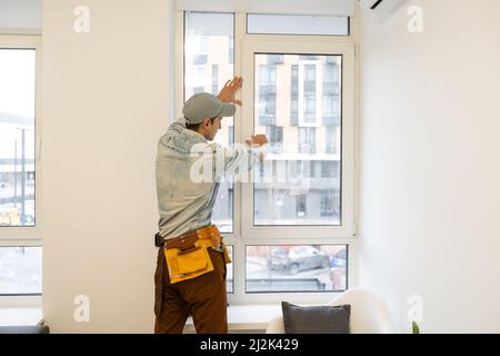 master changer une fenêtre à double vitrage dans une fenêtre en plastique, vue latérale Banque D'Images