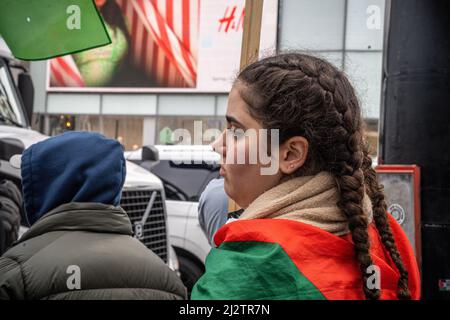 Toronto, Canada. 02nd avril 2022. Une jeune femme enveloppée d'un drapeau palestinien regarde pendant la manifestation. Des manifestants se sont rassemblés au Yonge-Dundas Square, à Toronto, au Canada, en solidarité avec la Palestine. Crédit : SOPA Images Limited/Alamy Live News Banque D'Images