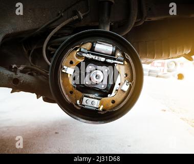 Composant à l'intérieur du tambour de frein automobile sans roue sur le pont hydraulique de la voiture dans le garage de réparation automatique Banque D'Images