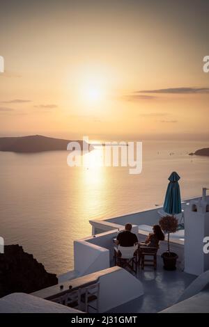 Couple profitant du coucher du soleil, vue de Fira à la caldeira de Santorini, Santorini, Cyclades, Mer Egéé, Mer méditerranée, Grèce, Europe Banque D'Images