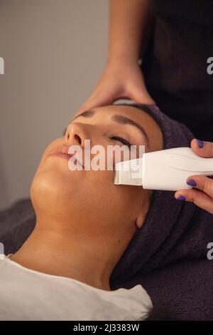 Massage du visage. Gommage du visage par ultrasons. Détendez-vous. Gommage du visage aux ultrasons. Détente Banque D'Images