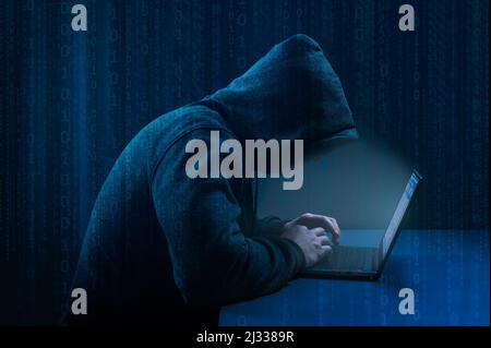 Hacker. Pirate utilisant un ordinateur portable sur fond numérique de code binaire sombre. Attaque dangereuse de hacker à capuche. Se divise en serveurs de données. Piratage et programmes malveillants conc Banque D'Images