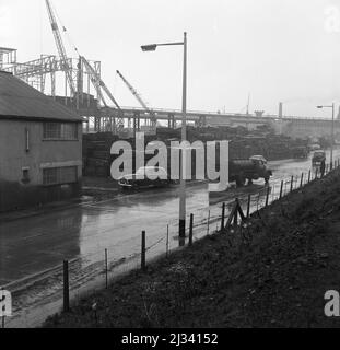 1950s, route historique à côté de la centrale d'acier géante d'Abbey Works, Port Talbot, pays de Galles, Royaume-Uni, où des travaux de construction ont lieu. Banque D'Images