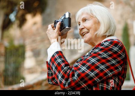 Portrait d'une femme âgée souriant en ville Banque D'Images